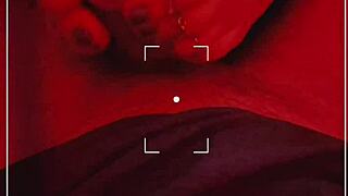 Seductive footjob and toe ring play under sultry red lights