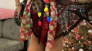 Anna Maria, a mature and professional adult star wears red lingerie in a Christmas themed video