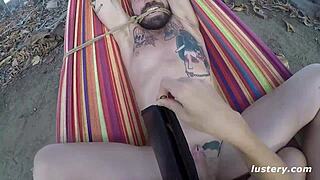 Sex in a hammock outside for a kinky couple