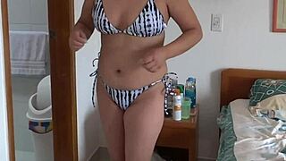 Mature blonde Latina flaunts her big assets by the sea