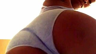 A girl in small panties is dancing and showing her big pussy