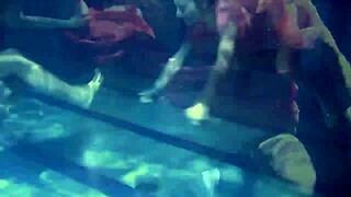 Lilia Mihalkova and Natalia Kupalka as underwater lesbians in tight swimwear