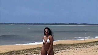 Portuguese brunette shows pussy in thong on Porto Seguro beach.