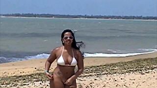 Portuguese brunette shows pussy in thong on Porto Seguro beach.