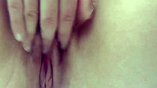 Wet brunette Julia toys pussy in bath