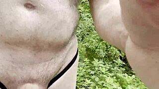 Gay guy strokes big cock solo in the woods