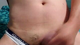 Gay boy relaxes while masturbating in underwear.