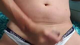 Gay boy relaxes while masturbating in underwear.