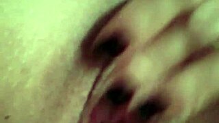 she strips slowly, touching her wet pussy with a dildo