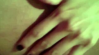 she strips slowly, touching her wet pussy with a dildo