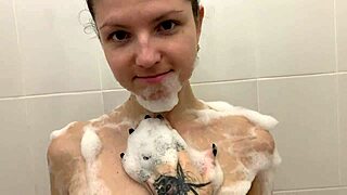 Blonde teen relaxes in bubble bath on webcam