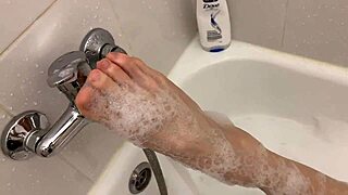 Blonde teen relaxes in bubble bath on webcam