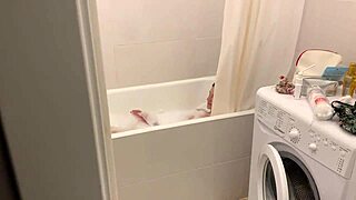 Blonde teen relaxes in bubble bath on webcam