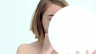 young looner babe blowing and popping her first balloon