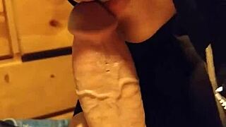 The stepsister is sucking her stepfather's cock, leading to a cumshot.