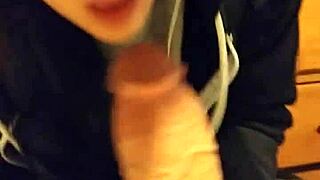 The stepsister is sucking her stepfather's cock, leading to a cumshot.