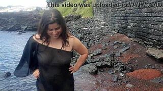 My stepmom relaxing on a public beach with natural curves