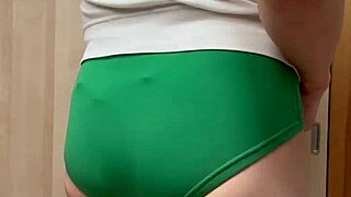 Blue-haired maid in sexy lingerie enjoys playful accessory fun with style.