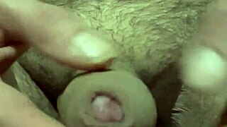 Solo guy plays with foreskin and balls then shoots load into camera
