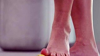 petite brunette crushes fruits with bare feet in heels