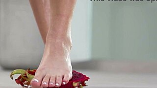 petite brunette crushes fruits with bare feet in heels