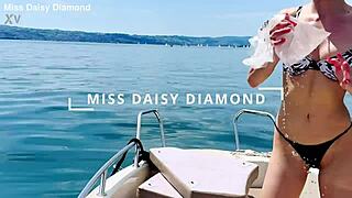 Beautiful housewife washes boat in sexy thong swimsuit outdoors