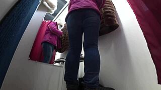 A hidden camera spies on juicy pawg legs in a public mall fitting room.