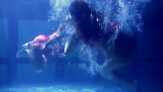 Lilia Mihalkova and Natalia Kupalka as underwater lesbians in tight swimwear
