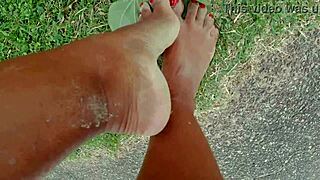 African pornstar walks barefoot on public beach, dirtying feet in fetish fun.