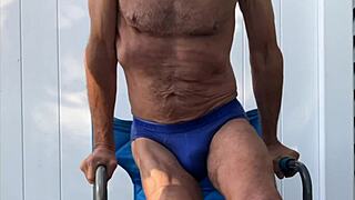 Deep Pelvic Stretching In Blue Briefs On Blue Chair