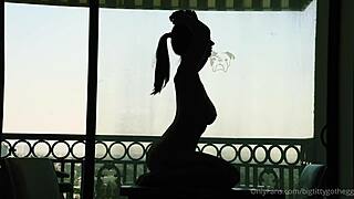 bigtittygothegg rides her dildo in silhouette, showing off shaved pussy