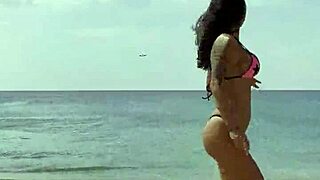 monika fox poses in pink bikini on beach