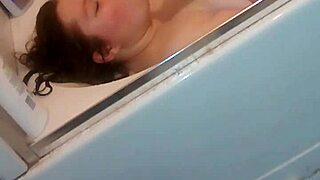 Gloria masturbating with dildo in bathtub