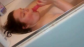 Gloria masturbating with dildo in bathtub