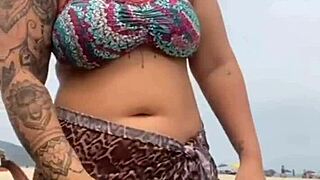 young african girl gets naked on beach, grabs guy's hard cock