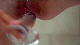 busty redhead masturbates with clear dildo closeup