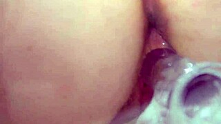 busty redhead masturbates with clear dildo closeup