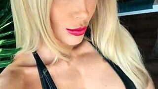 Woman in wetlook suit and patent leather boots licks ass