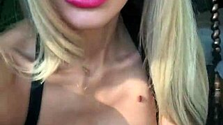 Woman in wetlook suit and patent leather boots licks ass