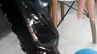 veve performs balloon popping in latex stockings