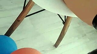 veve performs balloon popping in latex stockings