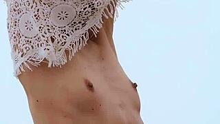 Skinny milf undresses naked playing with balloons on beach