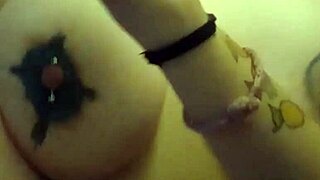 Woman with pierced nipples teases huge tits and wet pussy