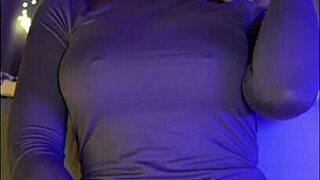 A redhead with blue eyes in a net passionately rides a dildo and plays with cum