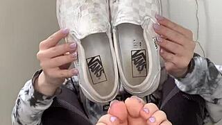 Girl removes sneakers to show bare feet