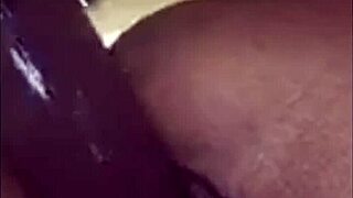 Why does this ebony babe moan while playing with her wet pussy using a big dildo?