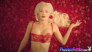 Petite blonde teen strips and poses among red petals