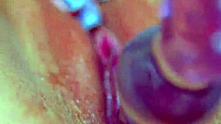 Girls' puffy shaved pussy gets wet with glass dildo in sensual amateur play