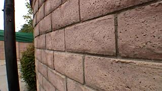 blonde woman interacts with big black man