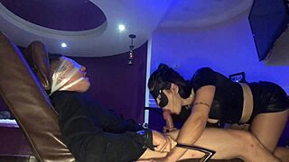 in the shadows, the dominatrix starts her secret blowjob with the submissive brunette